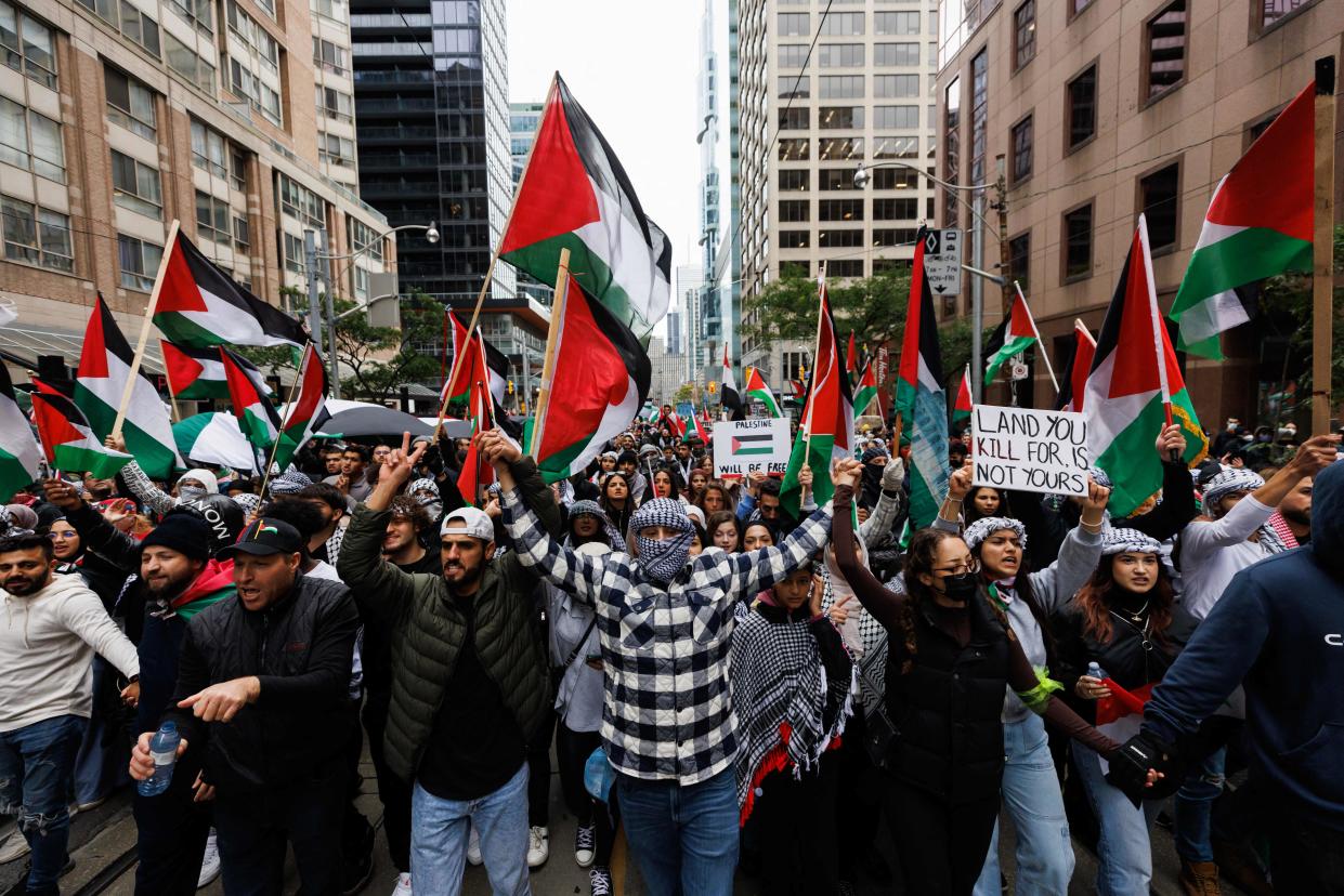 Demonstrators in support of Palestinians wave Palestinian flags during a protest in Toronto, Ontario, Canada, on October 9, 2023.(Cole Burston/AFP via Getty Images)