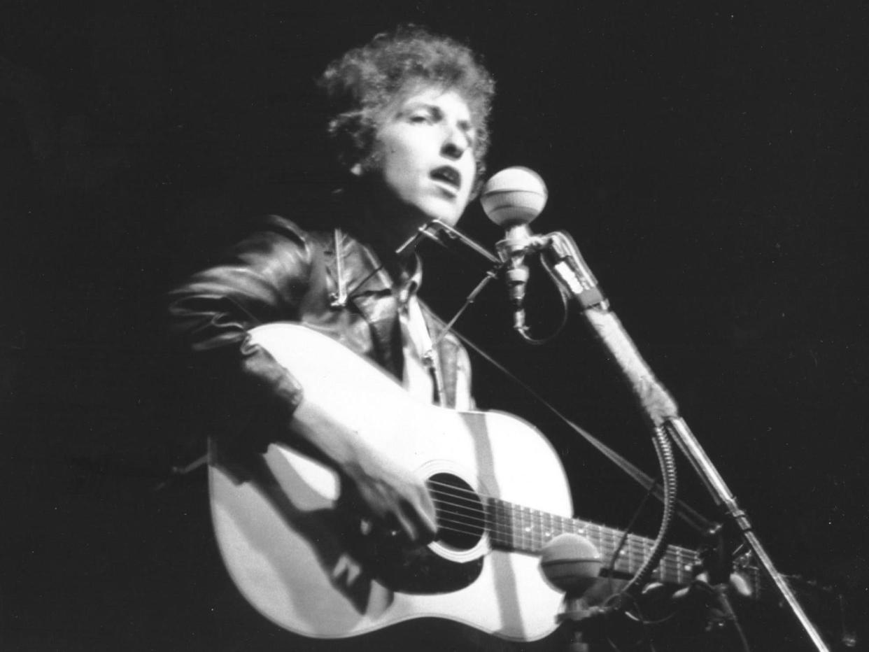 Bob Dylan performs at Rhode Island's Newport Folk Festival in July 1965: Getty