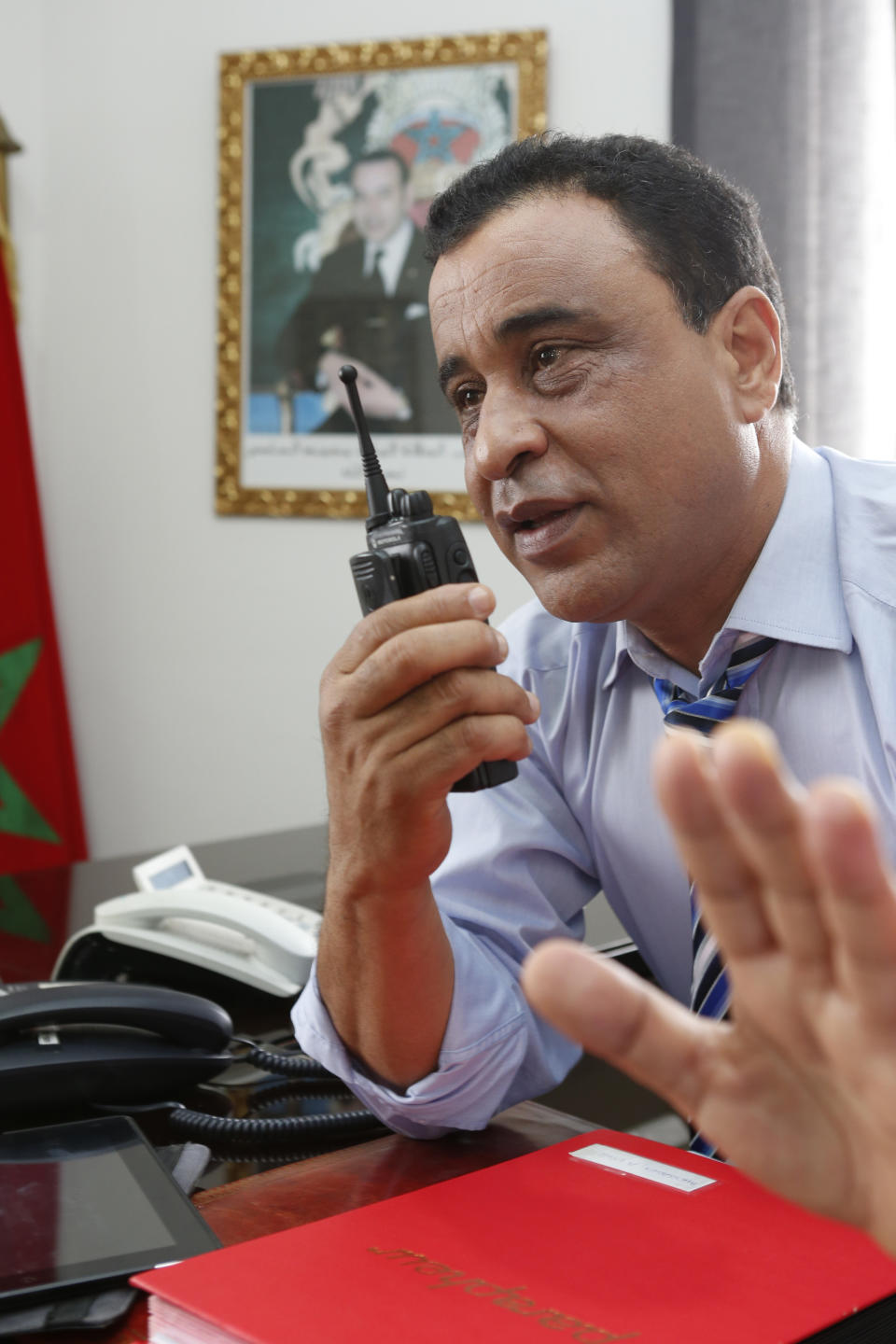 This Sunday April 27, 2014 photo shows the Chief of police of the neighborhoods of Al-Fida Mers Sultan department of Casablanca, Ahmed Kaabouch, speaking to his men through a walky-talky, during an interview with The Associated Press in, Casablanca. Casablanca in particular has always had a crime problem. It is a city of extremes, with skyscrapers and highend nightlife on one hand and the other the crushing poverty that spawned the angry youth who killed 33 people in a spate of bombings in 2003.(AP Photo / Abdeljalil Bounhar)