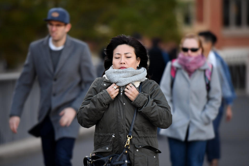 Pedestrians in Sydney's CBD are seen in scarves and jackets during June 2018. 