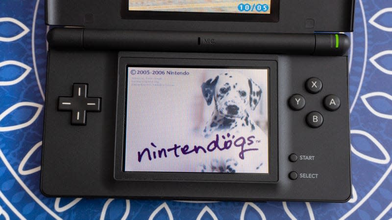 A black Nintendo DS handheld console with the Nintendogs' splash screen on the device's touchscreen display.