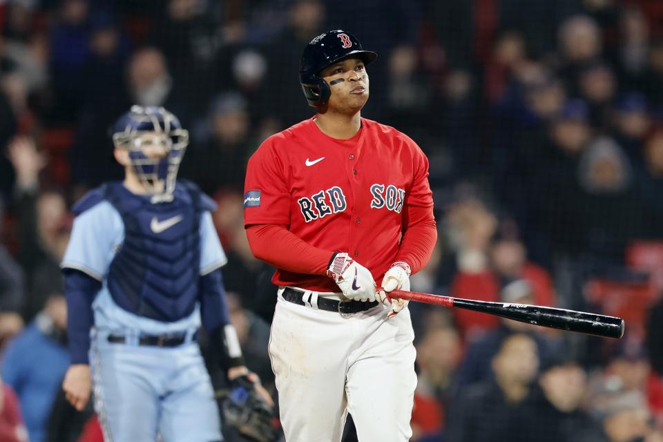 Boston Red Sox's Rafael Devers, right, watches his two-run home run in front of Toronto Blue Jays' Danny Jansen during the eighth inning of a baseball game, Thursday, May 4, 2023, in Boston. (AP Photo/Michael Dwyer)