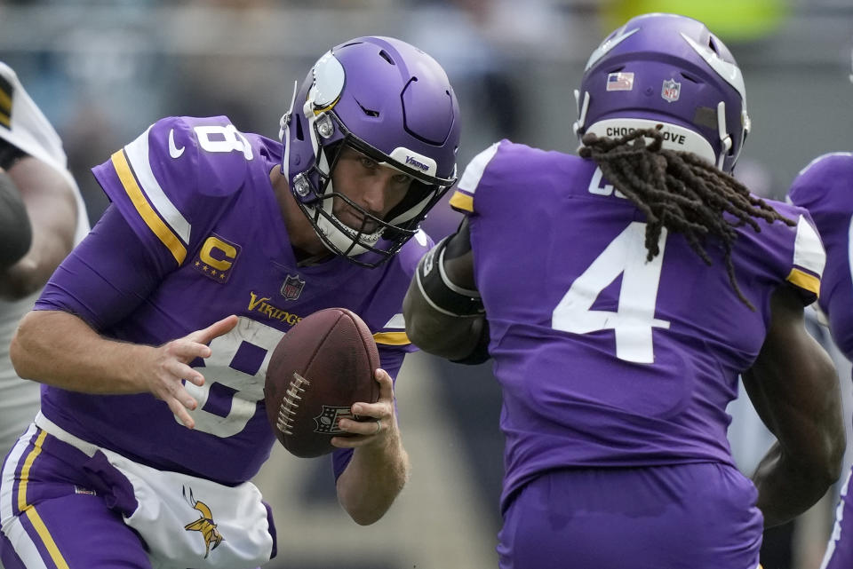 Minnesota Vikings quarterback Kirk Cousins (8) hands off to Minnesota Vikings running back Dalvin Cook (4) during an NFL match between Minnesota Vikings and New Orleans Saints at the Tottenham Hotspur stadium in London, Sunday, Oct. 2, 2022. (AP Photo/Frank Augstein)