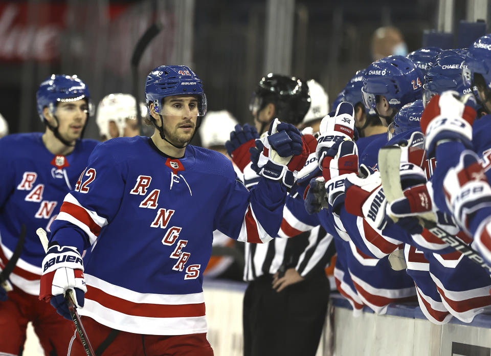 New York Rangers' Brendan Smith (42) celebrates his goal with teammates on the bench in the first period against the Philadelphia Flyers during an NHL hockey game Thursday, April 22, 2021, in New York. (Elsa/Pool Photo via AP)