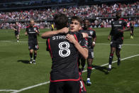 DC United's Jared Stroud (8) is congratulated after scoring a goal during the first half of an MLS soccer match against Inter Miami at Audi Field, Saturday, March 16, 2024, in Washington. (AP Photo/Nathan Howard)