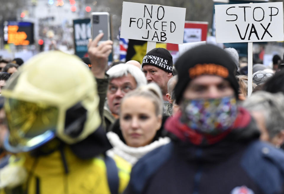 Demonstrators march during a protest against coronavirus measures in Brussels, Belgium, Sunday, Dec. 5, 2021. Hundreds of people marched through central Brussels on Sunday to protest tightened COVID-19 restrictions imposed by the Belgian government to counter the latest spike in coronavirus cases. (AP Photo/Geert Vanden Wijngaert)