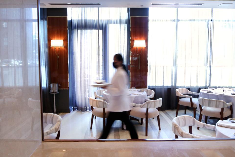 A server delivers an order at Bellini restaurant at the Beatrice Hotel in downtown Providence last fall. Restaurants continue to struggle with a worker shortage, as well as supply-chain problems.
