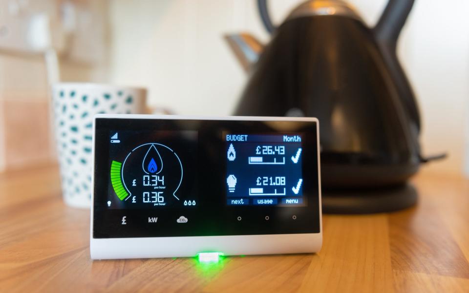  Close up detail of a smart energy in home display monitor for a smart meter, kettle in background - Chris Hepburn /iStockphoto 