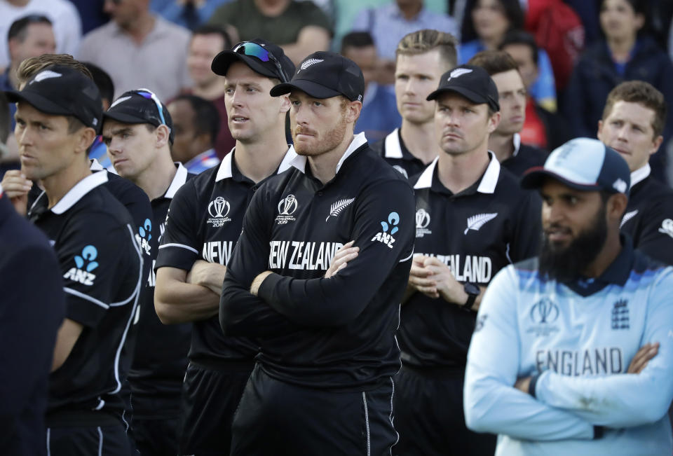 New Zealand's Martin Guptill, center, waits for the trophy presentation after losing the Cricket World Cup final match between England and New Zealand at Lord's cricket ground in London, Sunday, July 14, 2019. England won after a super over after the scores ended tied after 50 overs each. (AP Photo/Matt Dunham)