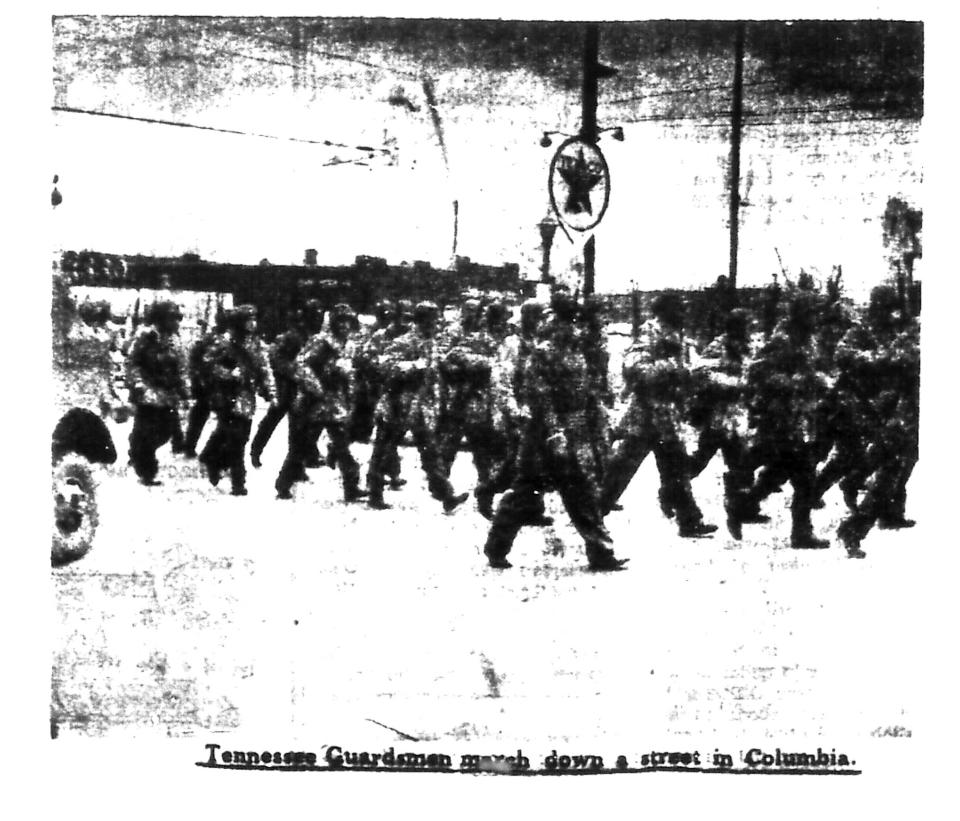 This image published in The Daily Herald on Thursday, Feb. 28, 1946 shows group of Tennessee guardsmen marching through downtown Columbia.