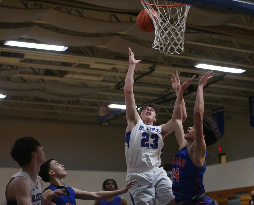 Millbrook's Andrew Szostak goes to the net against Seward's Joe Staszeski during the Section 9 Class C championship on February 28, 2024.