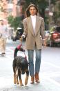 Emily Ratajkowski looks photo shoot-ready in a chic oversized blazer, white turtleneck and jeans as she takes her dog for a walk on Thursday in New York City.