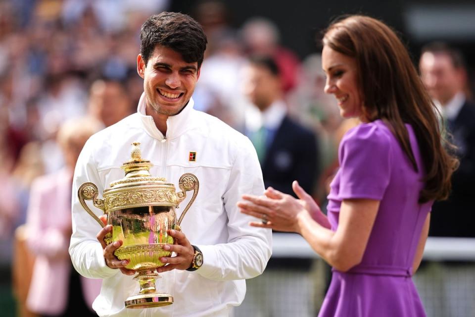 Carlos Alcaraz is presented with the trophy by the Princess of Wales (Aaron Chown/PA). (PA Wire)