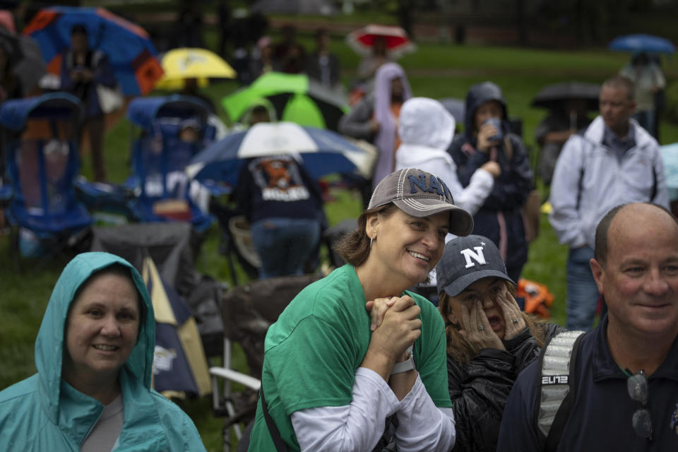 Attendees watch Plebes climb the Herndon Monument at the U.S. Naval Academy, Wednesday, May 15, 2024, in Annapolis, Md. Freshmen, known as Plebes, participate in the climb to celebrate finishing their first year at the academy. The climb was completed in two hours, nineteen minutes and eleven seconds. (AP Photo/Tom Brenner)