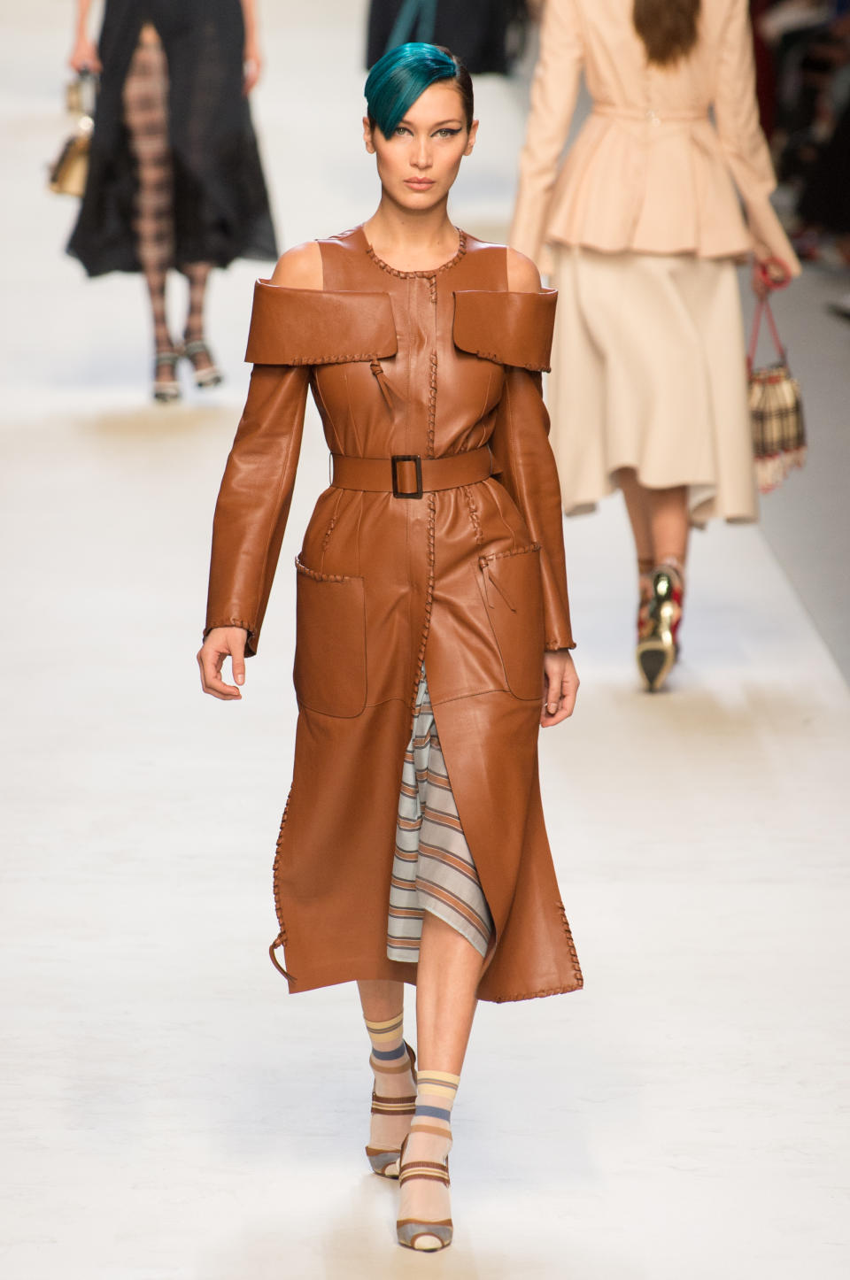 <p><i>Model Bella Hadid wears a brown cold-shoulder belted dress from the SS18 Fendi show. (Photo: ImaxTree) </i></p>
