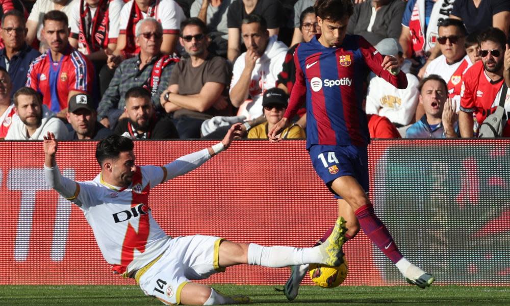 Rayo Vallecano’s Kike Pérez (left) fights for the ball with João Félix of Barcelona.