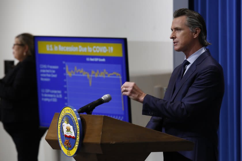 FILE — In this May 14, 2020 file photo Gov. Gavin Newsom discusses his revised 2020-2021 state budget during a news conference in Sacramento, Calif. In a joint statement Newsom and the Democratic Leaders of the Legislature announced on Monday June 22, 2020, that they have agreed to a state spending plan that would cover the state's estimated $54.3 billion dollar budget deficit. (AP Photo/Rich Pedroncelli, Pool, File)