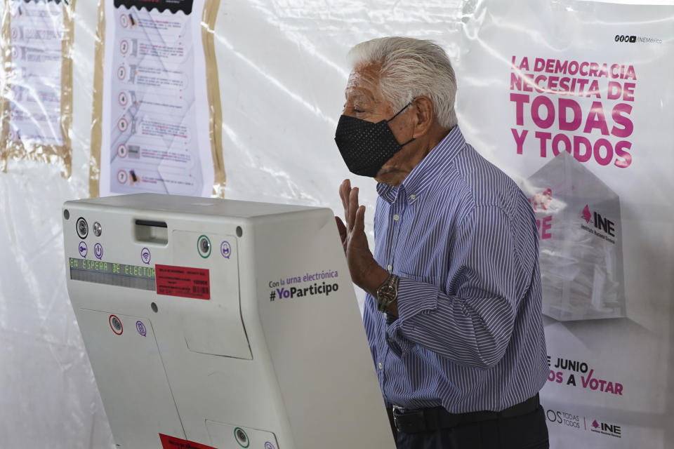 A man casts his ballot during the local state elections in Cuautitlán Izcalli, Mexico state, Mexico, Sunday, June 4, 2023. (AP Photo/Marco Ugarte)