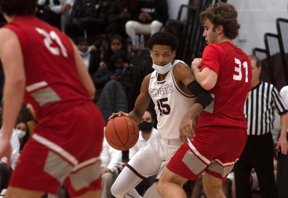 Abington senior Derrius Lucas attempts to pass through Upper Dublin junior Seaton Kukla at Abington Senior High School on Friday, Jan. 28. Upper Dublin boys basketball defeated Abington 59-47.