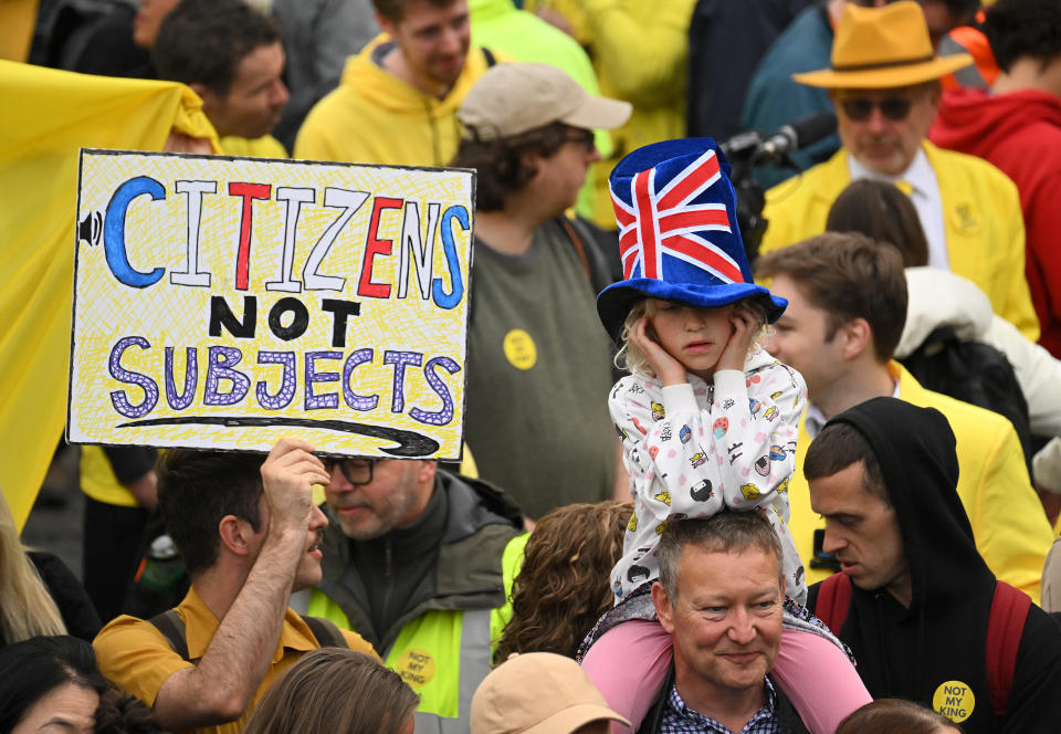 LONDON, ENGLAND - MAY 06: A person holds up a placard reading "Citizens not subjects" in Trafalgar Square ahead of the Coronation of King Charles III and Queen Camilla on May 6, 2023 in London, England. The Coronation of Charles III and his wife, Camilla, as King and Queen of the United Kingdom of Great Britain and Northern Ireland, and the other Commonwealth realms takes place at Westminster Abbey today. Charles acceded to the throne on 8 September 2022, upon the death of his mother, Elizabeth II. (Photo by Sebastien Bozon - WPA Pool/Getty Images)