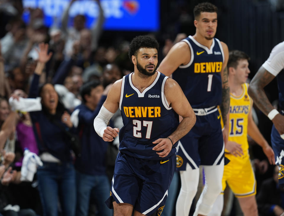 Denver Nuggets guard Jamal Murray (27) reacts after hitting the game-winning basket as forward Michael Porter Jr. looks on in the second half of Game 5 of an NBA basketball first-round playoff series against the Los Angeles Lakers Monday, April 29, 2024, in Denver. (AP Photo/David Zalubowski)