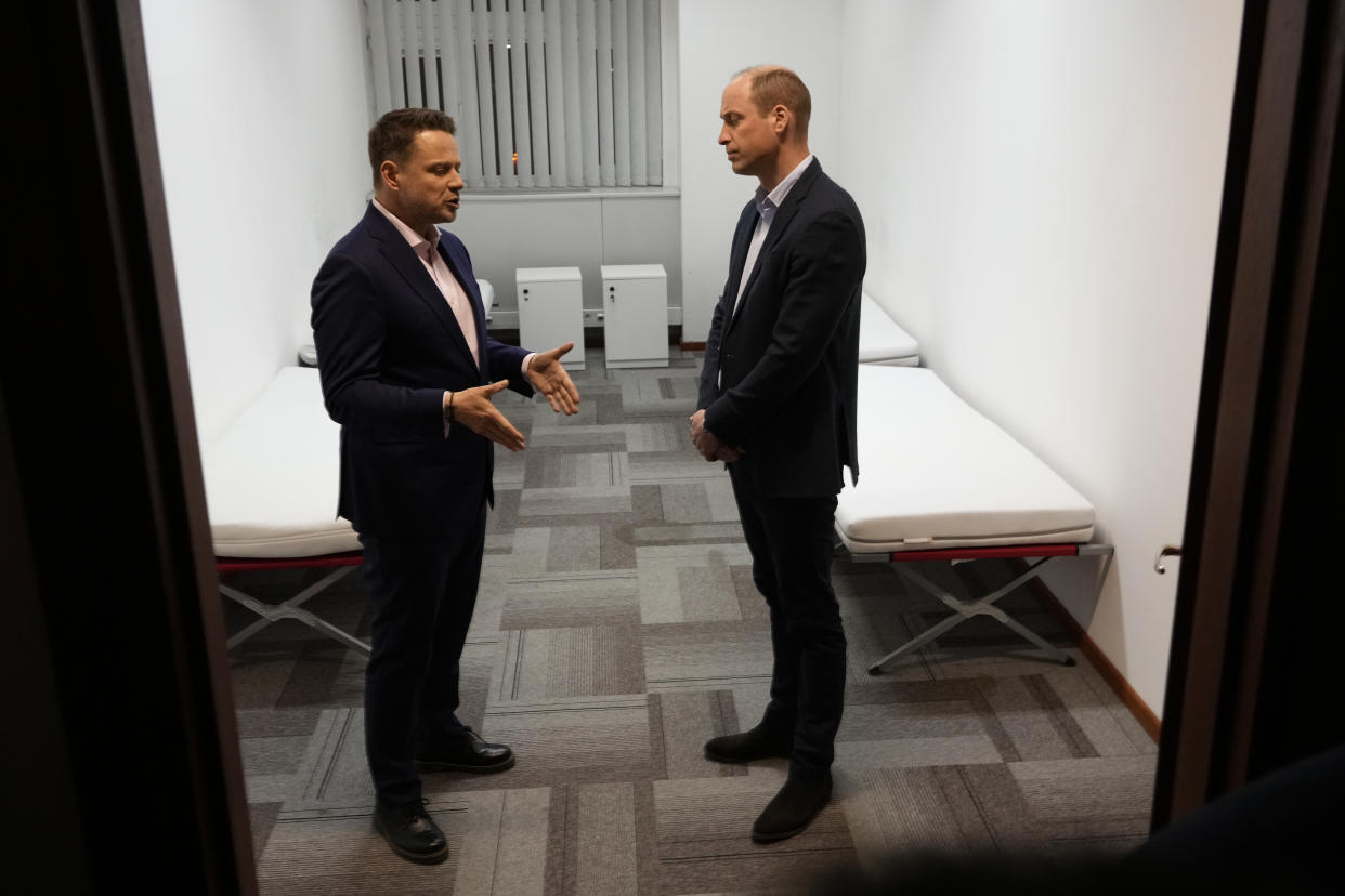 Britain's Prince William, right, talks to Mayor of Warsaw Rafal Trzaskowski as they visit an accommodation centre, for Ukrainians who fled the war, in Warsaw, Poland, Wednesday, March 22, 2023. (AP Photo/Czarek Sokolowski)