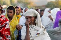 Woman stands in line to receive food donations, at the Tsehaye primary school in Shire