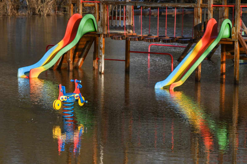 A general view of the flooded playground equipments at the Moenchpfiffel-Nikolausrieth playground. Heiko Rebsch/dpa