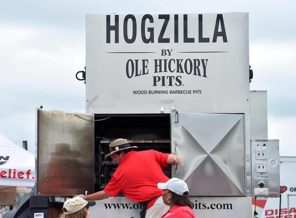 Nick Woolfolk with Ole Hickory Pits shuts the door after showing people the inside of “Hogzilla,” a Missouri-made pit. The three-day Kansas City BBQ Festival in the parking lot of the GEHA Field at Arrowhead Stadium concluded Sunday, July 11, 2021.