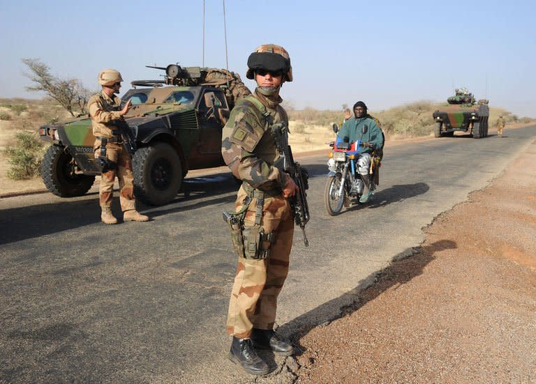 French soldiers guard a military convoy heading toward Gao on February 7, 2013 on the road from Gossi. Nearly a month after France sent in the first fighter jets and attack helicopters, it has largely driven the rebels into remote mountains in the far northeast. But the threat from the rebels is still very real