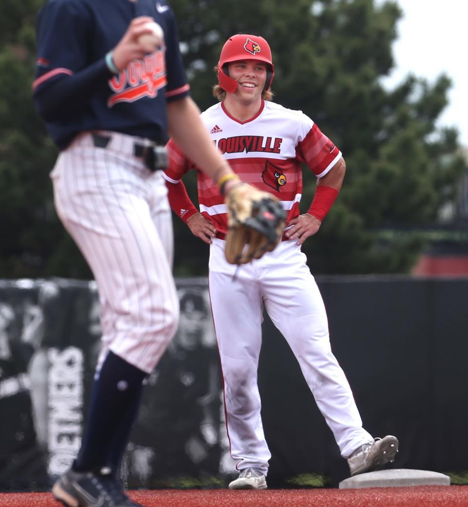 Louisville’s Dalton Rushing goes from 1st to 2nd against Virginia in the last game of the regular season.May 21, 2022