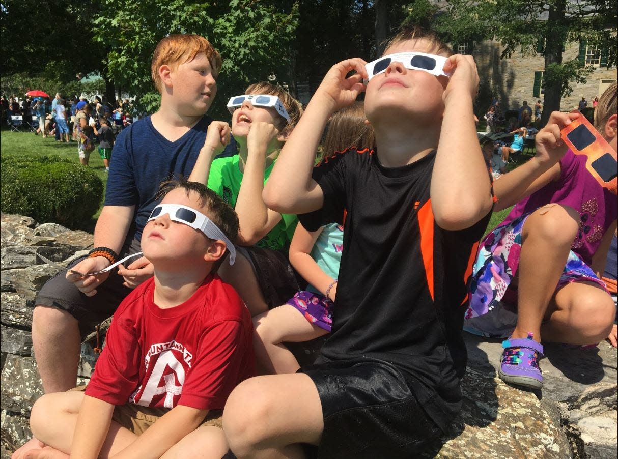 Kids look at the 2017 solar eclipse at an event held by Renfrew Institute (now called The Institute).