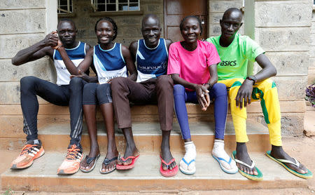 Athletes from South Sudan, part of the refugee athletes who qualified for the 2016 Rio Olympics, (L-R) Paulo Amotun Lokoro of 1500m, Rose Nathike Lokonyen of 800m, Yiech Pur Biel of 800m, Anjelina Nada Lohalith of 1500m and James Nyang Chiengjiek of 400m, pose for a photograph after a training session at their camp in Ngong township near Kenya's capital Nairobi, June 9, 2016. REUTERS/Thomas Mukoya/Files