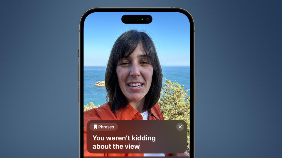 An iPhone on a blue background showing a woman using the Live Speech feature