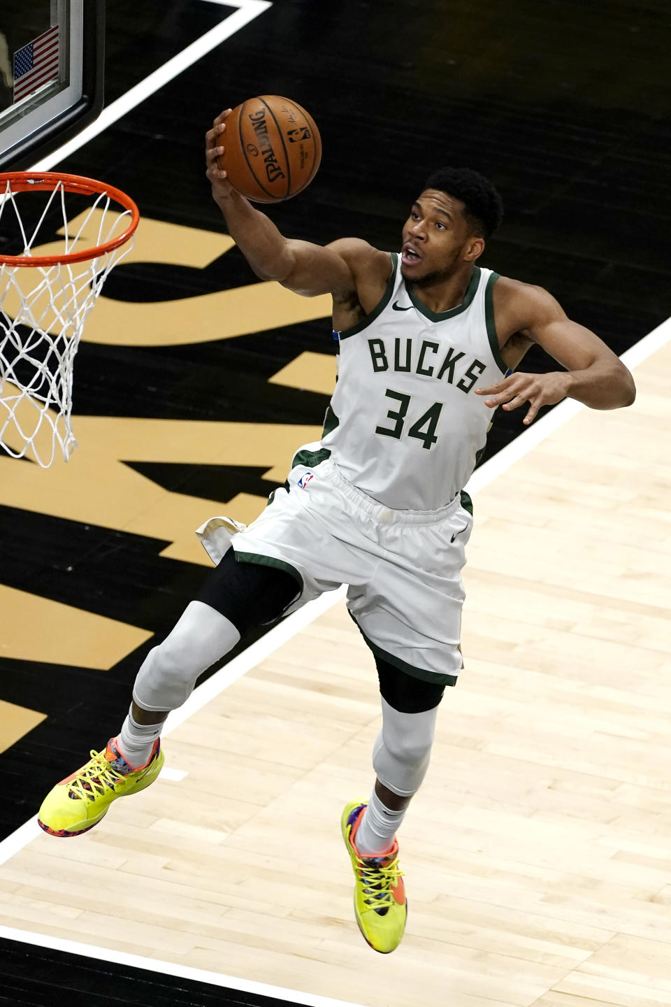 Milwaukee Bucks forward Giannis Antetokounmpo (34) goes in for a basket during the first half of the team's NBA basketball game against the Atlanta Hawks on Thursday, April 15, 2021, in Atlanta. (AP Photo/John Bazemore)