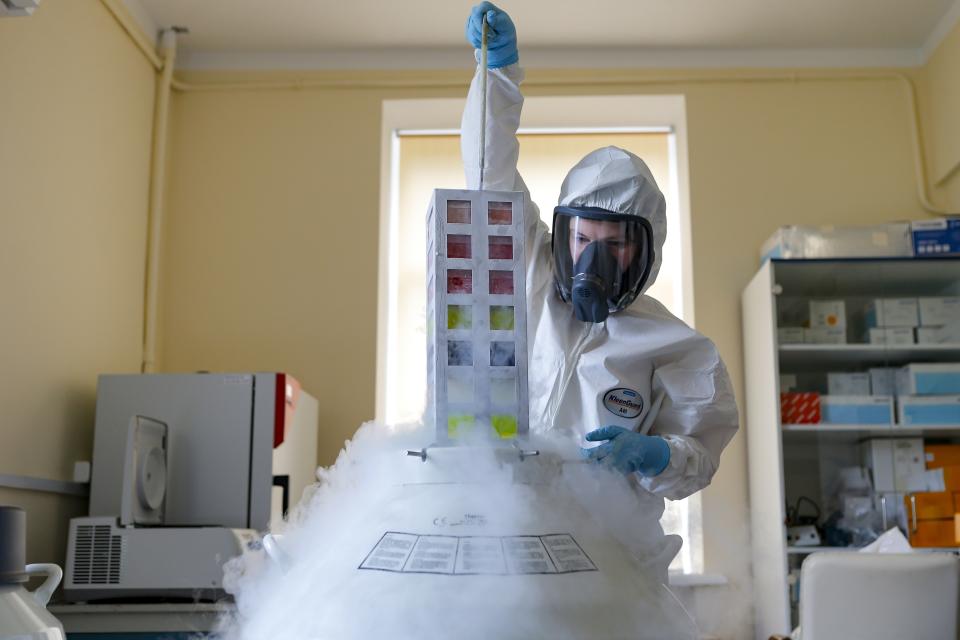 FILE - In this Aug. 6, 2020, file photo provided by Russian Direct Investment Fund, an employee works with a coronavirus vaccine at the Nikolai Gamaleya National Center of Epidemiology and Microbiology in Moscow, Russia. Millions in developing nations from Latin America to the Middle East also are waiting for more doses of Sputnik V after manufacturing woes and other issues have created huge gaps in vaccination campaigns. (Alexander Zemlianichenko Jr/Russian Direct Investment Fund via AP, File)