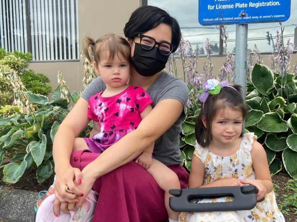 Megan Santiago Klassen sits outside an Abbotsford, B.C. vaccine clinic with her two children Mina and Enez, after they got their first immunization for COVID-19 on Tuesday. (Baneet Braich/CBC - image credit)