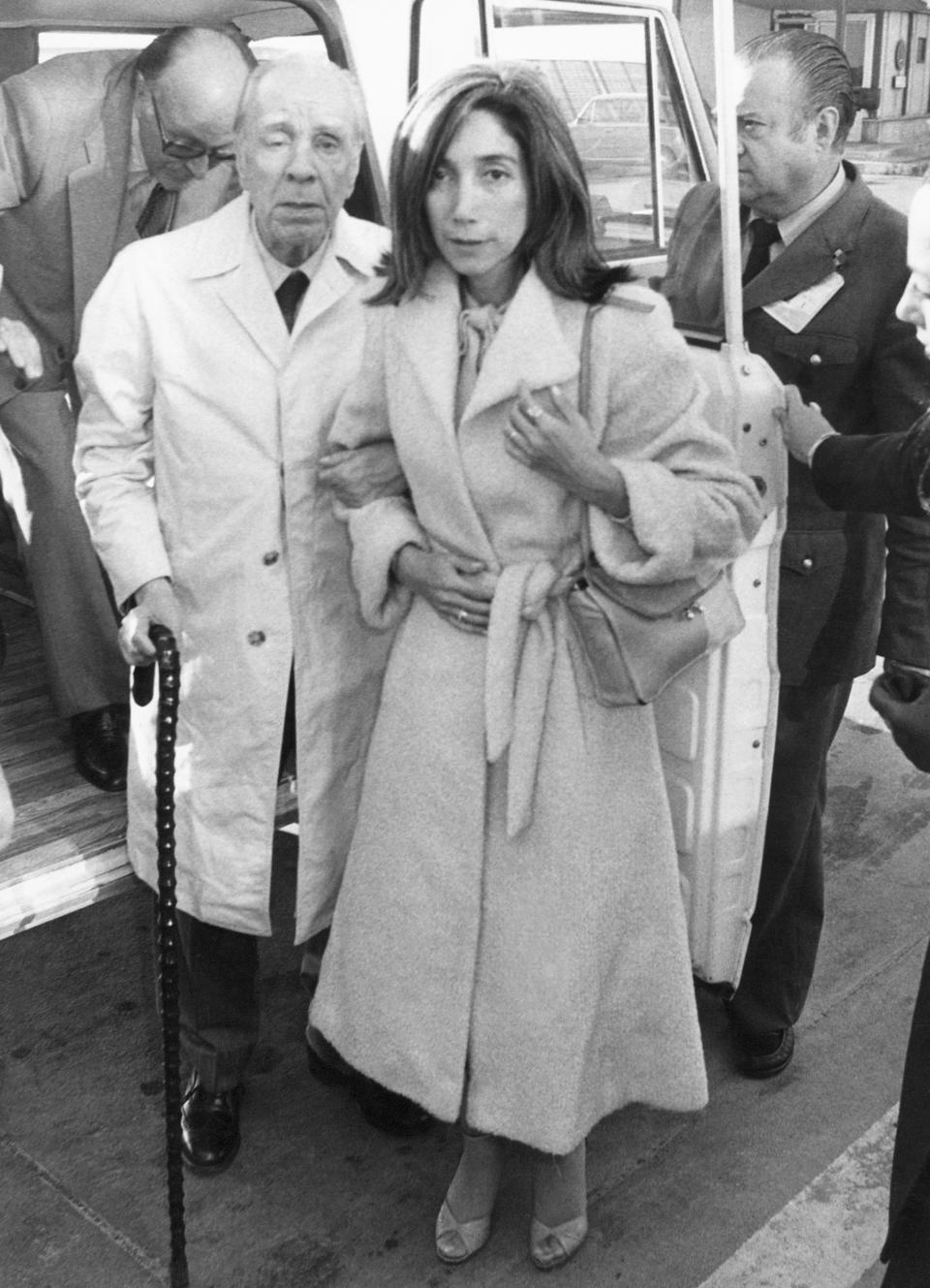 FILE - In this April 20, 1980 file photo, Argentine writer Jorge Luis Borges, accompanied by his secretary Maria Kodama, arrives in Madrid, Spain to receive the Spanish literary prize "Miguel de Cervantes." Kodama has died on Sunday, March 26, 2023. (AP Photo, File)