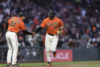 San Francisco Giants' Evan Longoria (10) celebrates with third base coach Mark Hallberg (91) as he runs the bases after hitting a home run against the Cincinnati Reds during the fourth inning of a baseball game in San Francisco, Friday, June 24, 2022. (AP Photo/John Hefti)