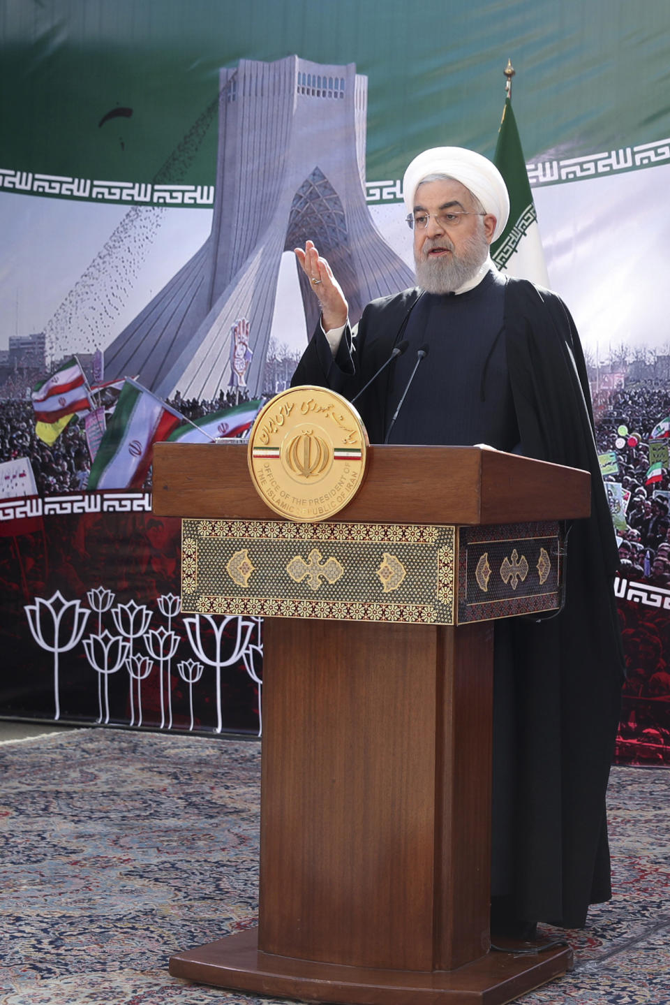 In this photo released by the official website of the office of the Iranian Presidency, President Hassan Rouhani addresses the nation in a televised speech in Tehran, Iran, Wednesday, Feb. 10, 2021. Rouhani said the West has no way except reaching an agreement with Tehran for restoring 2015 nuclear deal as the nation marked the anniversary of the country's 1979 Islamic Revolution on Wednesday on wheels - cars, motorcycles, bicycles - instead of traditional rallies and marches because of the region's worst outbreak of the coronavirus. (Iranian Presidency Office via AP)