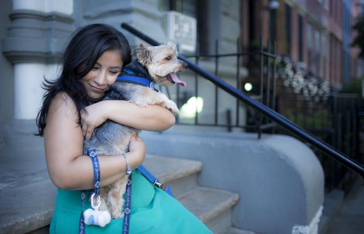 <span class="caption">Dior Vargas stops to hug her family dog during a walk. Dior is a mental health activist who lives with depression and anxiety. Dior founded the People of Color and Mental Illness.</span> <span class="attribution"><a class="link " href="https://www.gettyimages.com/detail/news-photo/dior-vargas-stops-to-hug-her-family-dog-during-a-walk-dior-news-photo/626452562?adppopup=true" rel="nofollow noopener" target="_blank" data-ylk="slk:Shaul Schwarz/Verbatim via Getty Images;elm:context_link;itc:0;sec:content-canvas">Shaul Schwarz/Verbatim via Getty Images </a></span>
