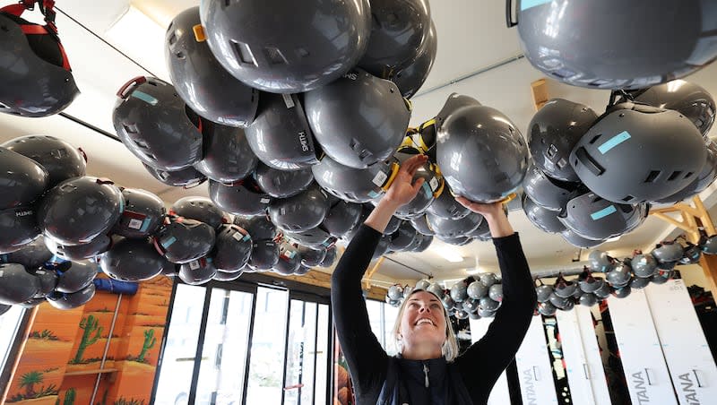 Ski Butlers general manager Sarah Shelton adjusts hanging ski helmets in Park City on Tuesday, March 19, 2024. The ski shop was awarded most trustworthy business in Utah.