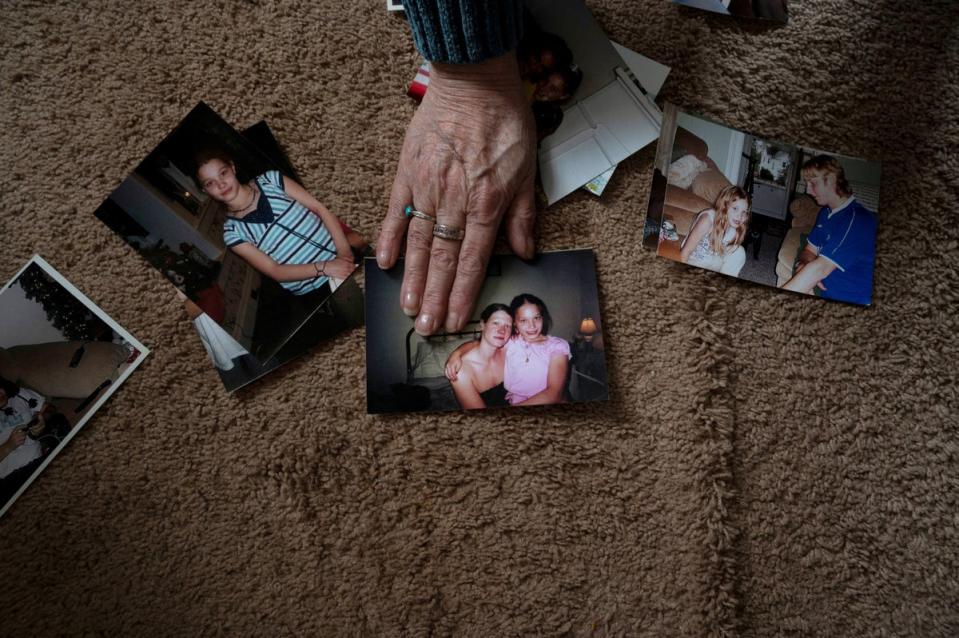 Cook Driscoll holds out a photo of her daughter and granddaughter (Reuters)