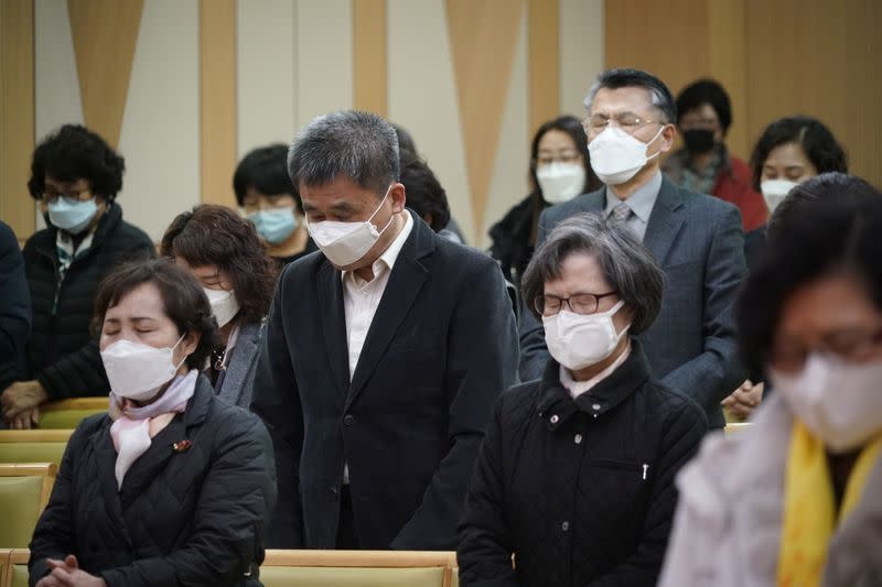 Christian faithful wearing masks to prevent contacting coronavirus pray during a service in Seoul