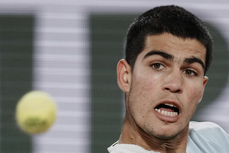 Spain's Carlos Alcaraz plays a shot against Russia's Karen Khachanov during their fourth round match at the French Open tennis tournament in Roland Garros stadium in Paris, France, Sunday, May 29, 2022. (AP Photo/Thibault Camus)