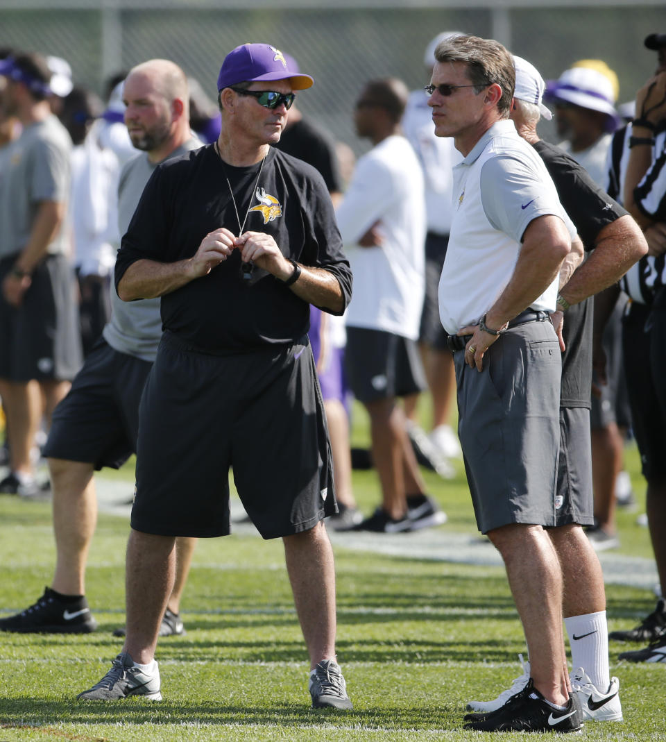 FILE - Minnesota Vikings head coach Mike Zimmer, left, and general manager Rick Spielman watch practice at an NFL football training camp on the campus of Minnesota State University Monday, July 27, 2015, in Mankato, Minn. The Minnesota Vikings fired general manager Rick Spielman and head coach Mike Zimmer on Monday, Jan. 10, 2022. (AP Photo/Charles Rex Arbogast, File)