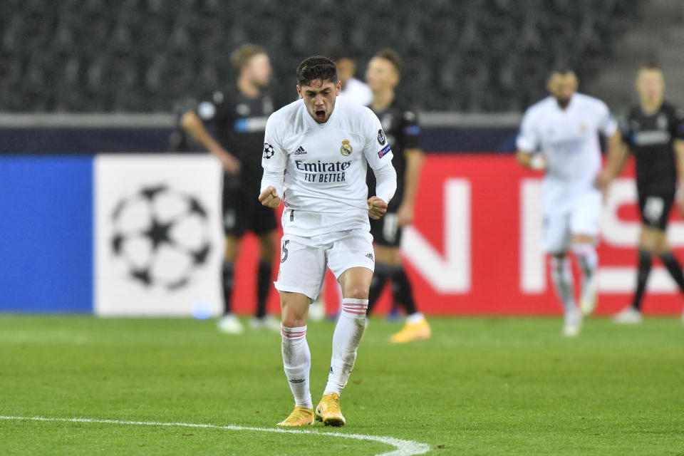 Real Madrid's Federico Valverde celebrates after Real Madrid's Casemiro scored his side's second goal during the Champions League group B soccer match between Borussia Moenchengladbach and Real Madrid at the Borussia Park in Moenchengladbach, Germany, Tuesday, Oct. 27, 2020. (AP Photo/Martin Meissner)