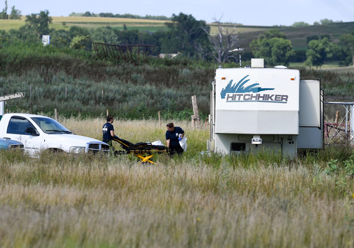 A stretcher is brought to the door of a camper as law enforcement investigates a crime scene off of Highway 38 on Thursday, August 18, 2022, outside of Sioux Falls.