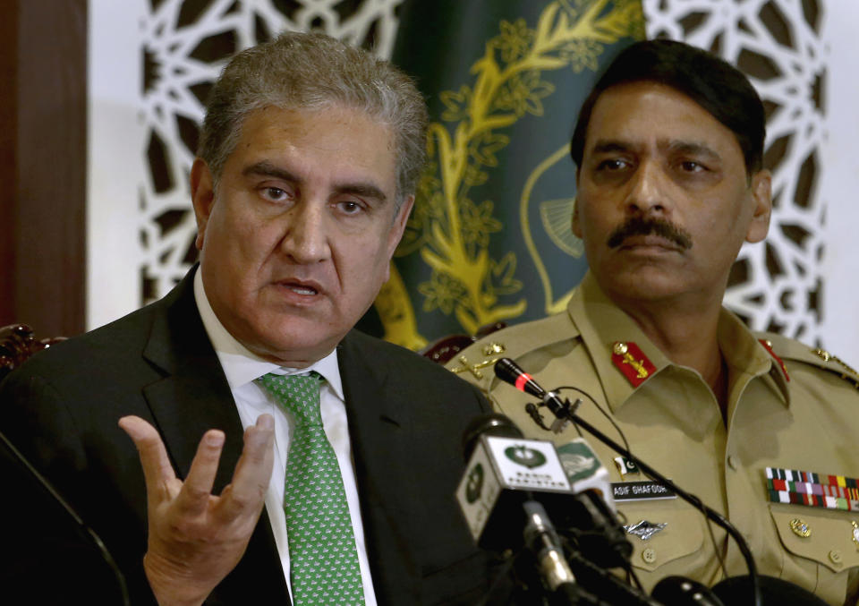 Pakistani Foreign Minister Shah Mahmood Qureshi, left, speaks while military spokesman Maj. Gen. Asif Ghafoor looks on during a press conference in Islamabad, Pakistan, Saturday, Aug. 17, 2019. Qureshi said the Security Council taking up Kashmir proved that it is an international dispute and not an internal matter of India as New Delhi claimed. He also told reporters in the Pakistani capital that it was possible India could resort to a military misadventure on the disputed border to deviate world's attention from human right violations and the clampdown in occupied Kashmir. (AP Photo/Anjum Naveed)