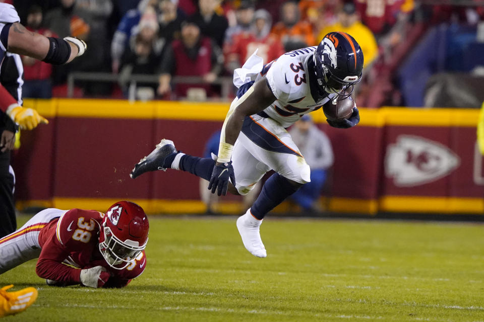 Denver Broncos running back Javonte Williams (33) runs with the ball past Kansas City Chiefs cornerback L'Jarius Sneed (38) during the first half of an NFL football game Sunday, Dec. 5, 2021, in Kansas City, Mo. (AP Photo/Ed Zurga)